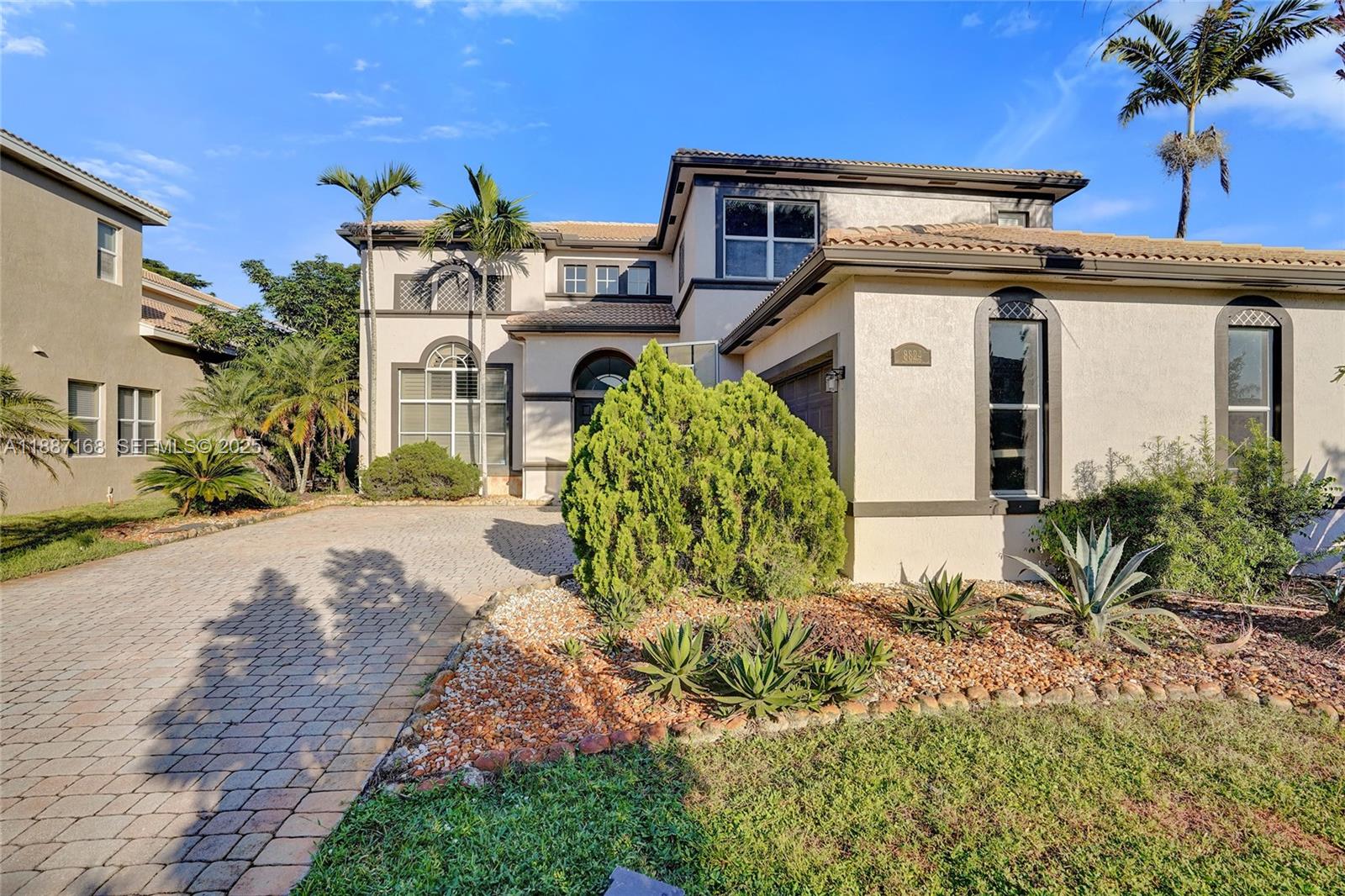 8824 Cobblestone Point Circle Boynton Beach, FL 33472 - Photo 2 of 53 a front view of a house with garden