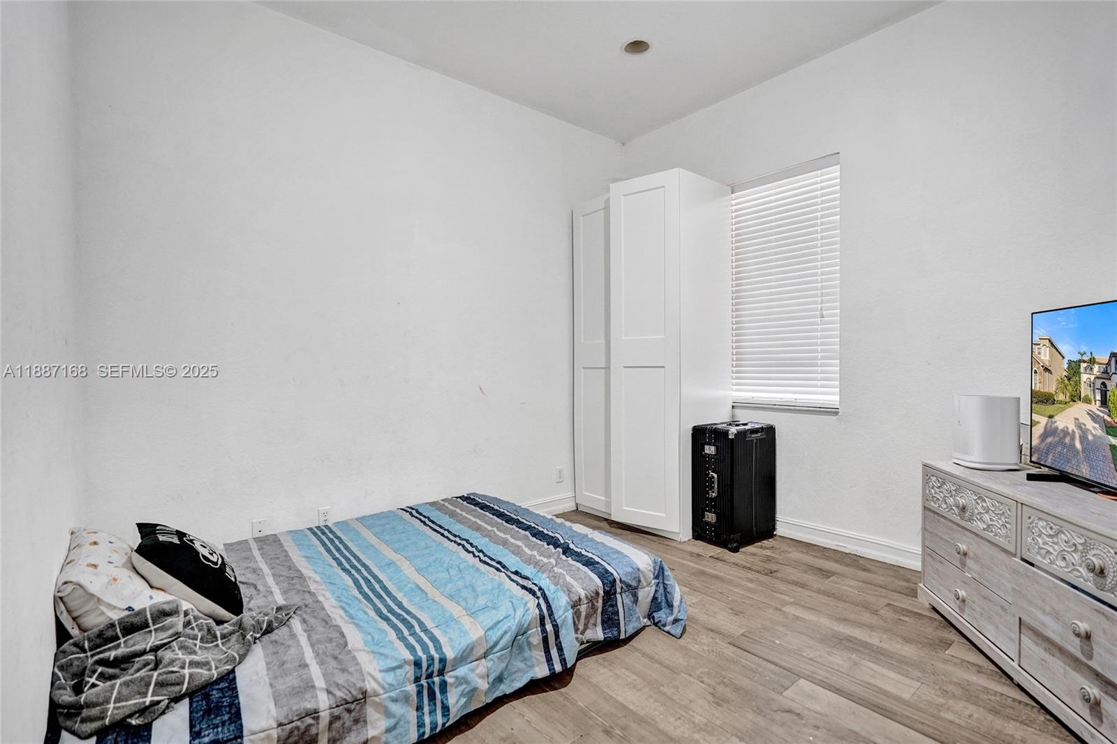 8824 Cobblestone Point Circle Boynton Beach, FL 33472 - Photo 23 of 53 a bedroom with a bed and a tv in it