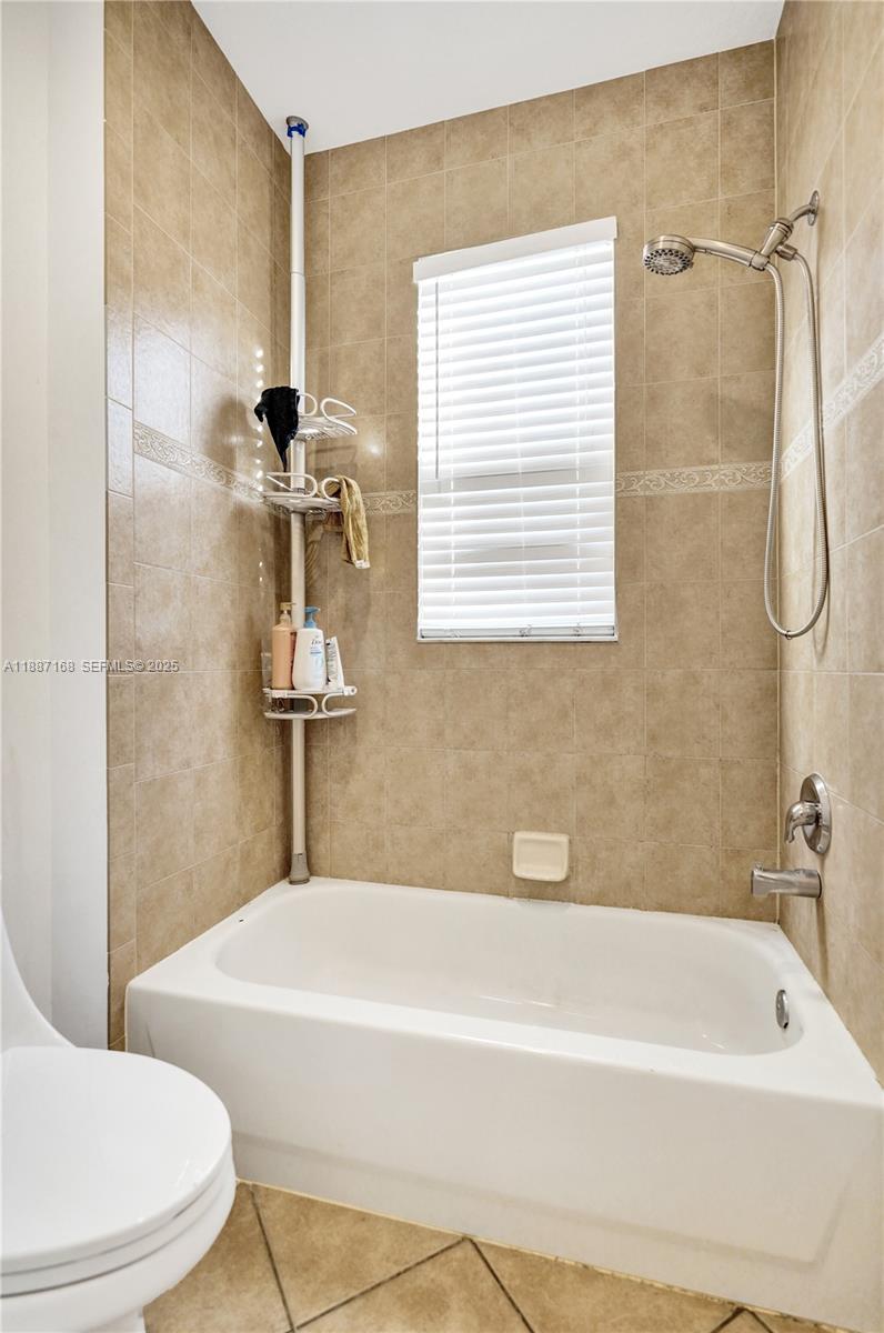 8824 Cobblestone Point Circle Boynton Beach, FL 33472 - Photo 28 of 53 a bathroom with a white bath tub a sink and a toilet