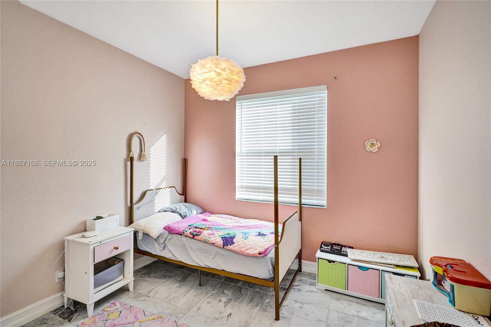 8824 Cobblestone Point Circle Boynton Beach, FL 33472 - Photo 29 of 53 a bedroom with a bed and a chandelier