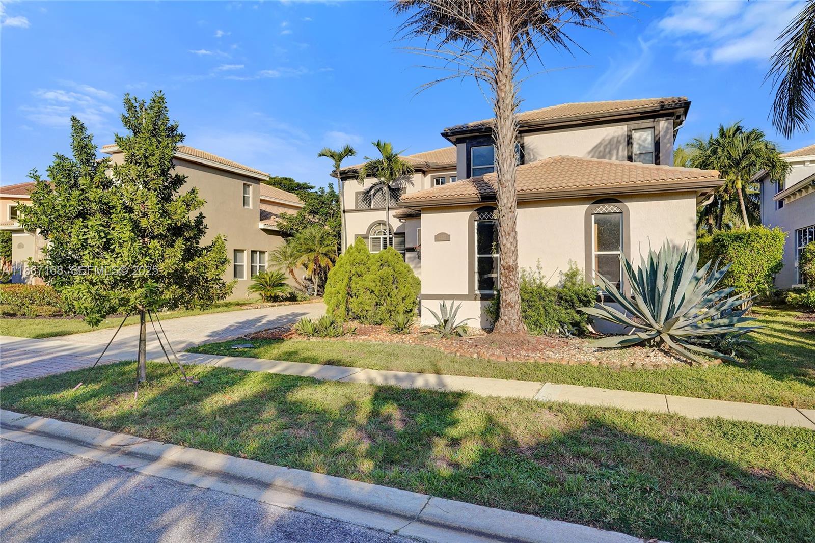8824 Cobblestone Point Circle Boynton Beach, FL 33472 - Photo 3 of 53 a front view of a house with garden