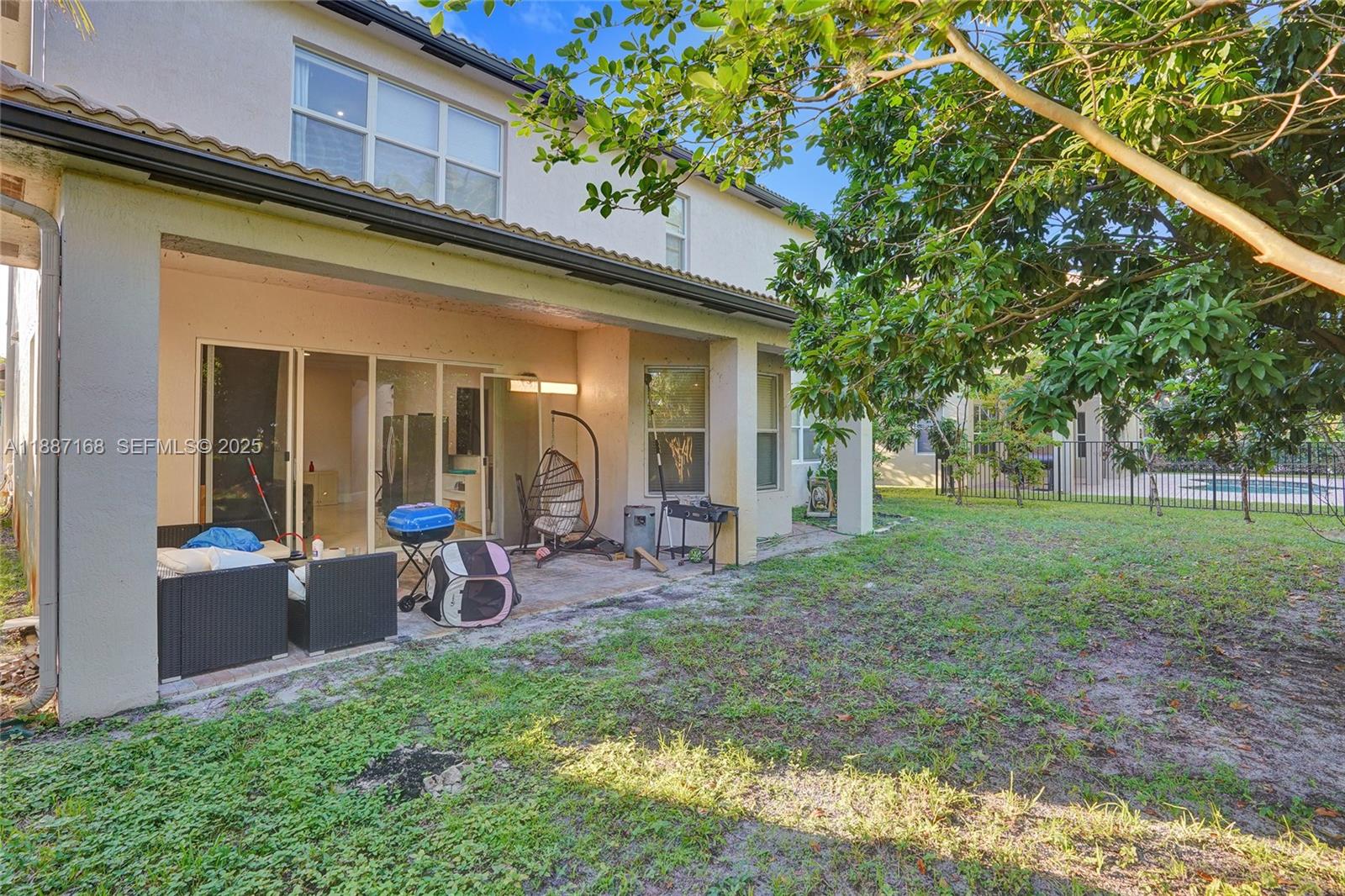 8824 Cobblestone Point Circle Boynton Beach, FL 33472 - Photo 42 of 53 a view of a house with backyard porch and sitting area