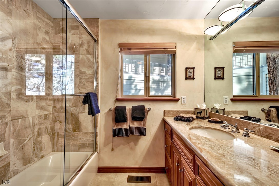 545 Alpine View Drive Incline Village, NV 89451 - Photo 23 of 34 a bathroom with a granite countertop sink and a bathtub