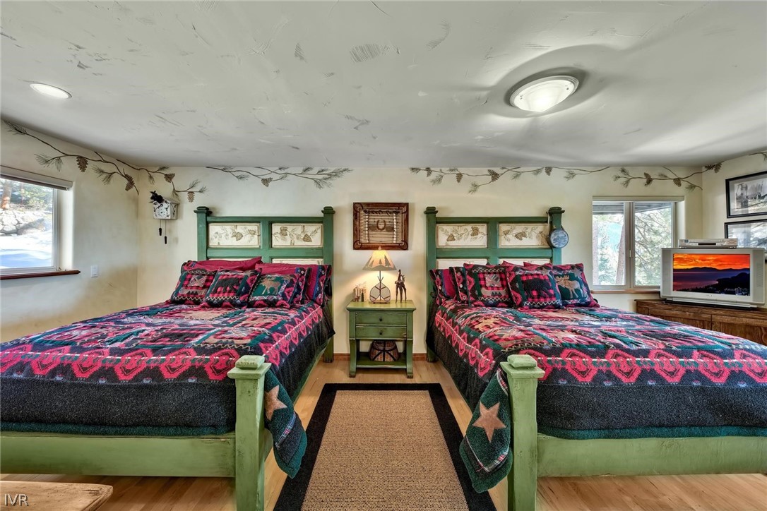 545 Alpine View Drive Incline Village, NV 89451 - Photo 24 of 34 a bedroom with two beds and a chandelier