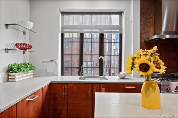 a bathroom with a granite countertop sink and a large mirror