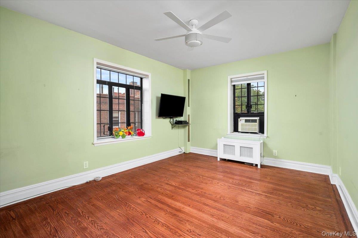 45 Pondfield Road West, Unit 4C Bronxville, NY 10708 - Photo 13 of 30 wooden floor in an empty room with a window