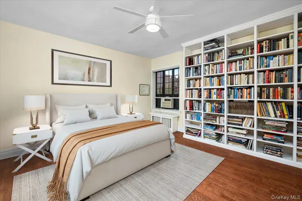 a bedroom with a bed cabinets and a book shelf