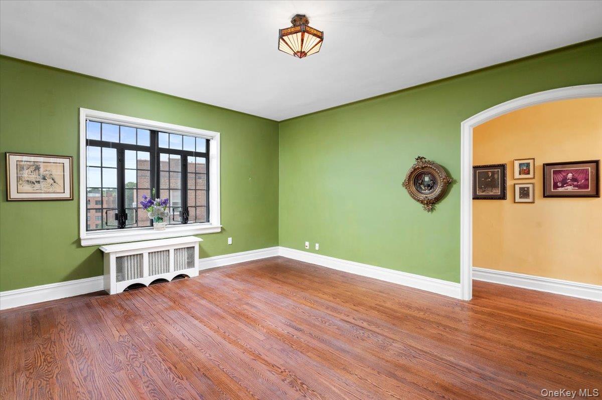 45 Pondfield Road West, Unit 4C Bronxville, NY 10708 - Photo 5 of 30 a view of an empty room with window and wooden floor