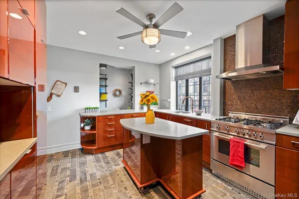 a kitchen with stainless steel appliances granite countertop a sink stove and refrigerator