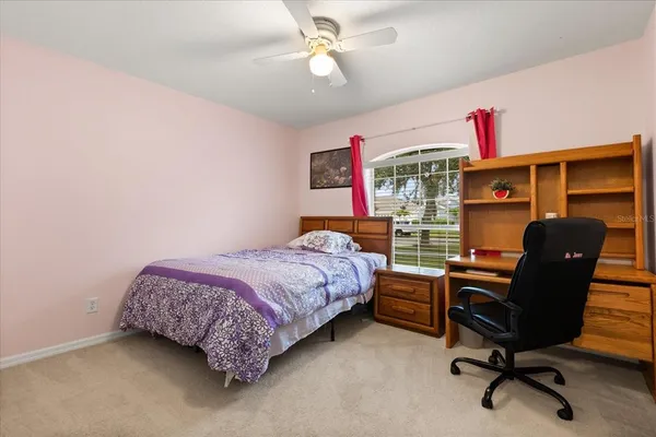 a bedroom with a bed and a desk