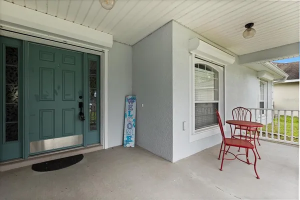a view of a hallway with chairs and front door