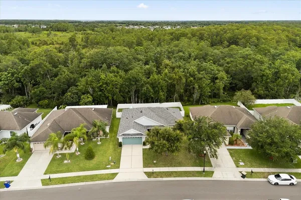 an aerial view of a house with a yard