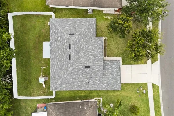 an aerial view of a house with a yard