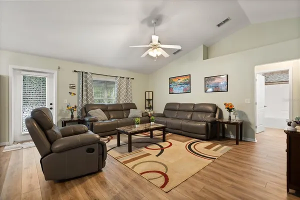 a living room with furniture a couch and wooden floor