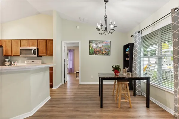 a view of a dining room with furniture window and wooden floor