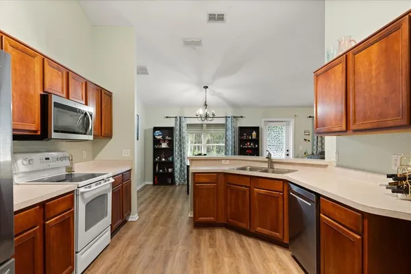 a kitchen with stainless steel appliances a sink stove and microwave