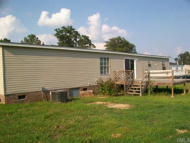 8035 Wiggins Mill Road Lucama, NC 27851 - Photo 3 of 5 a backyard of a house with table and chairs