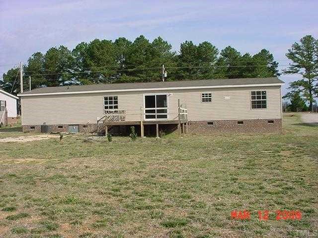 8035 Wiggins Mill Road Lucama, NC 27851 - Photo 5 of 5 a backyard of a house with wooden floor and fence