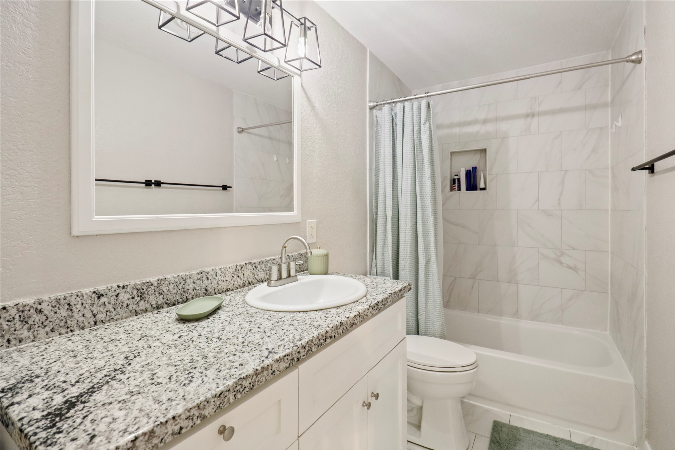 916 North Chenango Street Angleton, TX 77515 - Photo 11 of 15 a bathroom with a granite countertop sink a toilet and shower