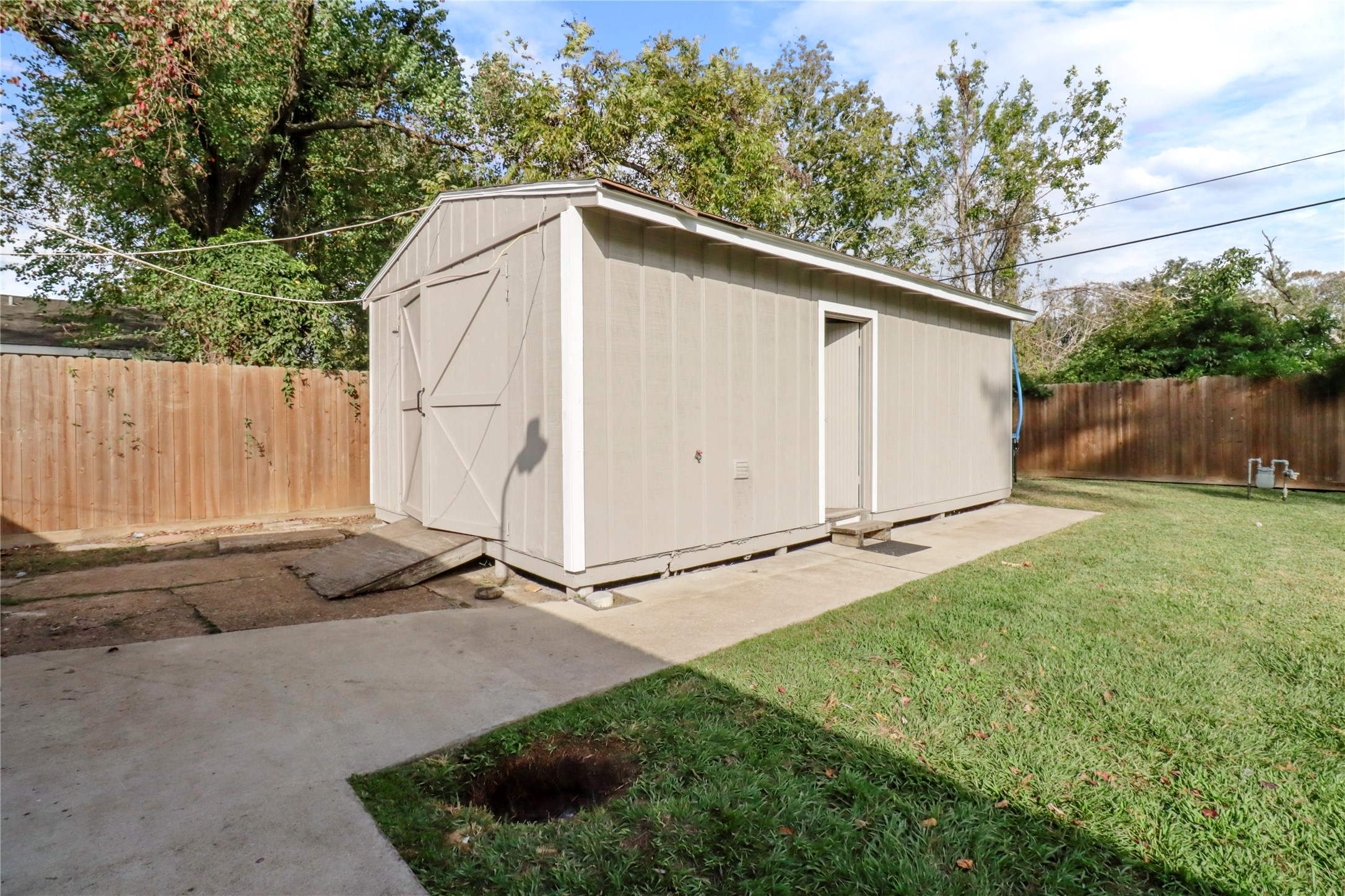 916 North Chenango Street Angleton, TX 77515 - Photo 13 of 15 a backyard of a house with lots of green space