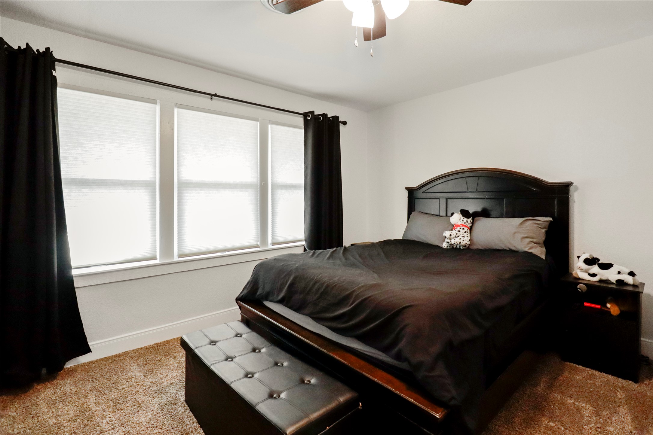 916 North Chenango Street Angleton, TX 77515 - Photo 8 of 15 a bedroom with a bed and window