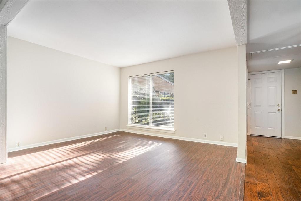 2945 Country Pl Circle Carrollton, TX 75006 - Photo 12 of 29 an empty room with wooden floor and windows