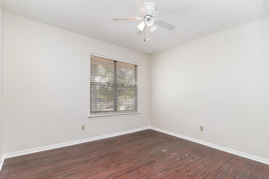 2945 Country Pl Circle Carrollton, TX 75006 - Photo 18 of 29 an empty room with wooden floor ceiling fan and window