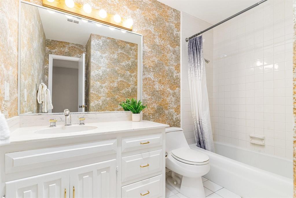 2945 Country Pl Circle Carrollton, TX 75006 - Photo 19 of 29 a bathroom with a sink a toilet and shower