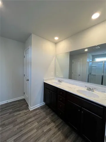 a bathroom with a double vanity sink and mirror