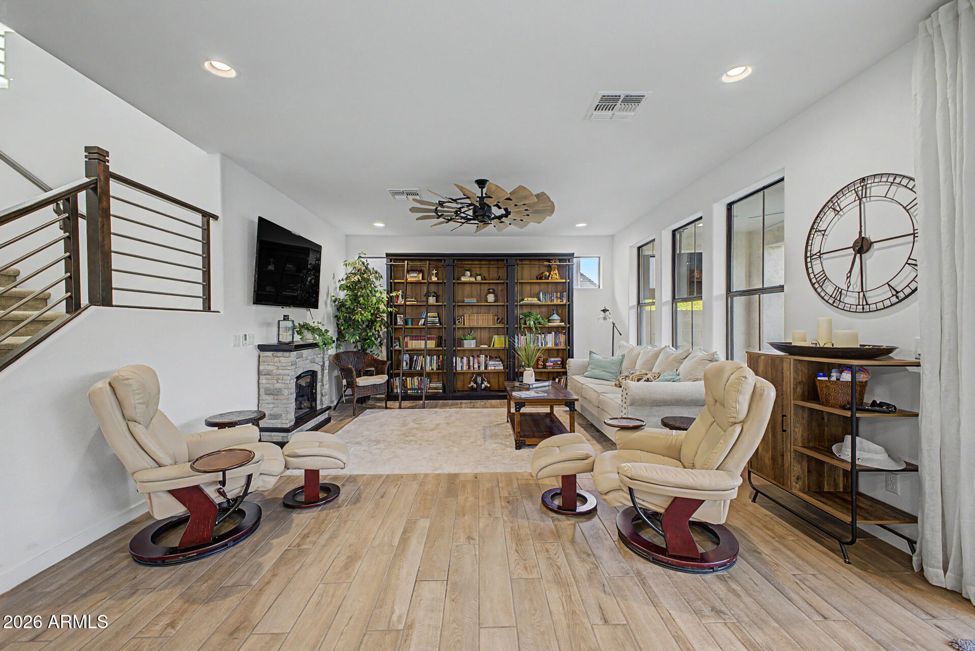 819 West Deer Creek Road Phoenix, AZ 85048 - Photo 23 of 76 a living room with furniture a fireplace and a flat screen tv