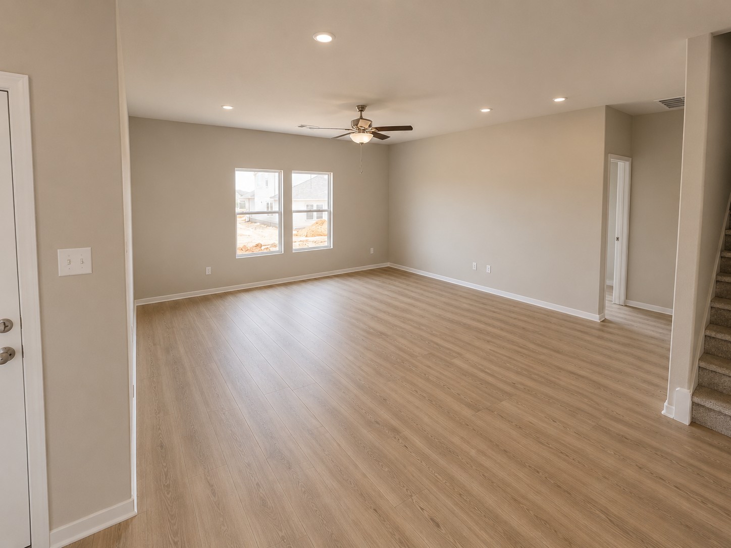 156 Wind Hill Jarrell, TX 76537 - Photo 6 of 22 an empty room with wooden floor ceiling fan and windows