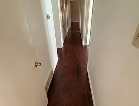 8620 Baltimore Drive, Unit 101 Dallas, TX 75225 - Photo 10 of 14 a view of a hallway with wooden floor and staircase
