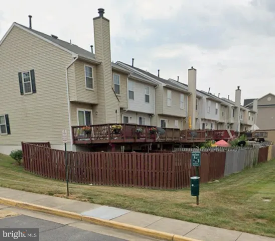 a view of a house with wooden fence