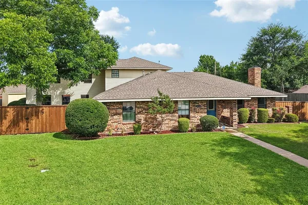 a view of a house with a yard and sitting area