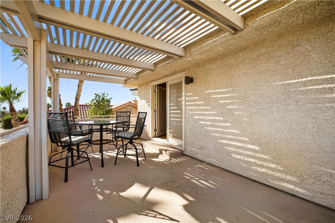 1135 Calico Ridge Drive Henderson, NV 89011 - Photo 38 of 86 Enjoy outdoor living on this charming patio, complete with a pergola and ample space for entertaining.