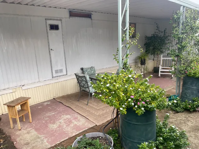 a view of a chair and table in the patio