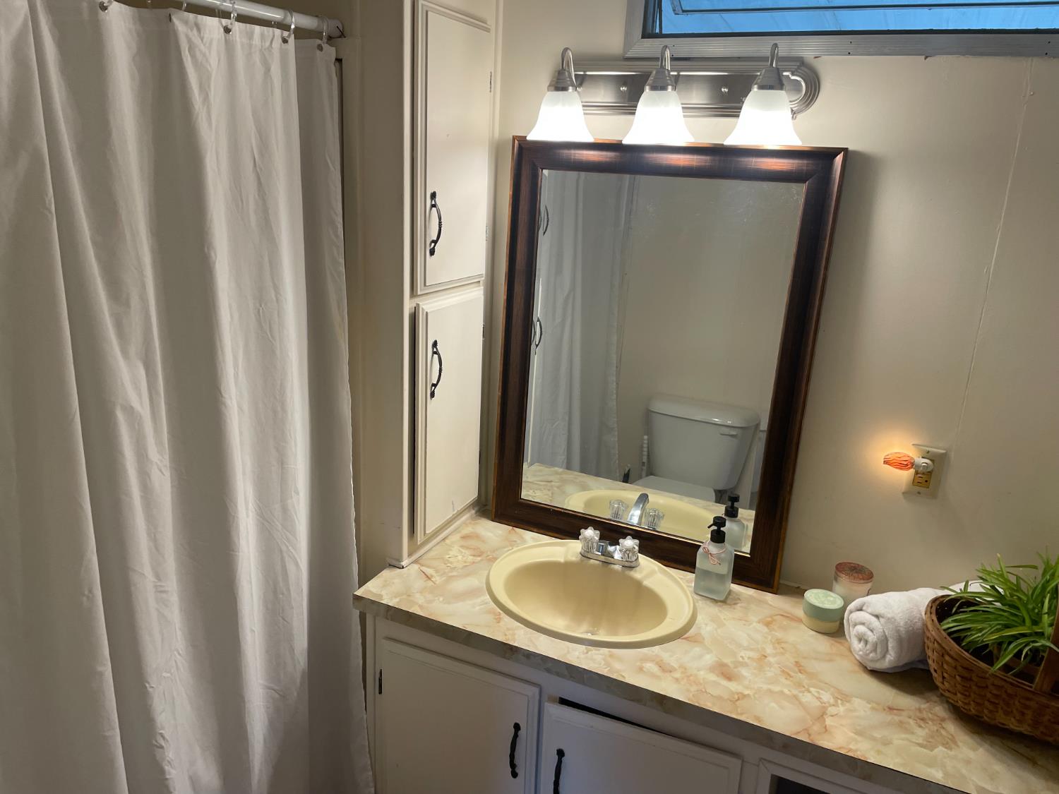 5835 Cherokee Road, Unit 42 Stockton, CA 95215 - Photo 5 of 24 a bathroom with a granite countertop sink and a mirror