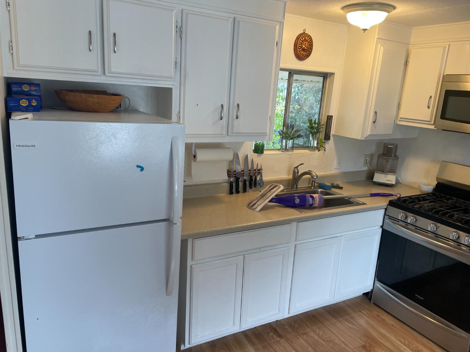 5835 Cherokee Road, Unit 42 Stockton, CA 95215 - Photo 8 of 24 a kitchen with stainless steel appliances granite countertop a refrigerator a stove a sink and a white cabinets