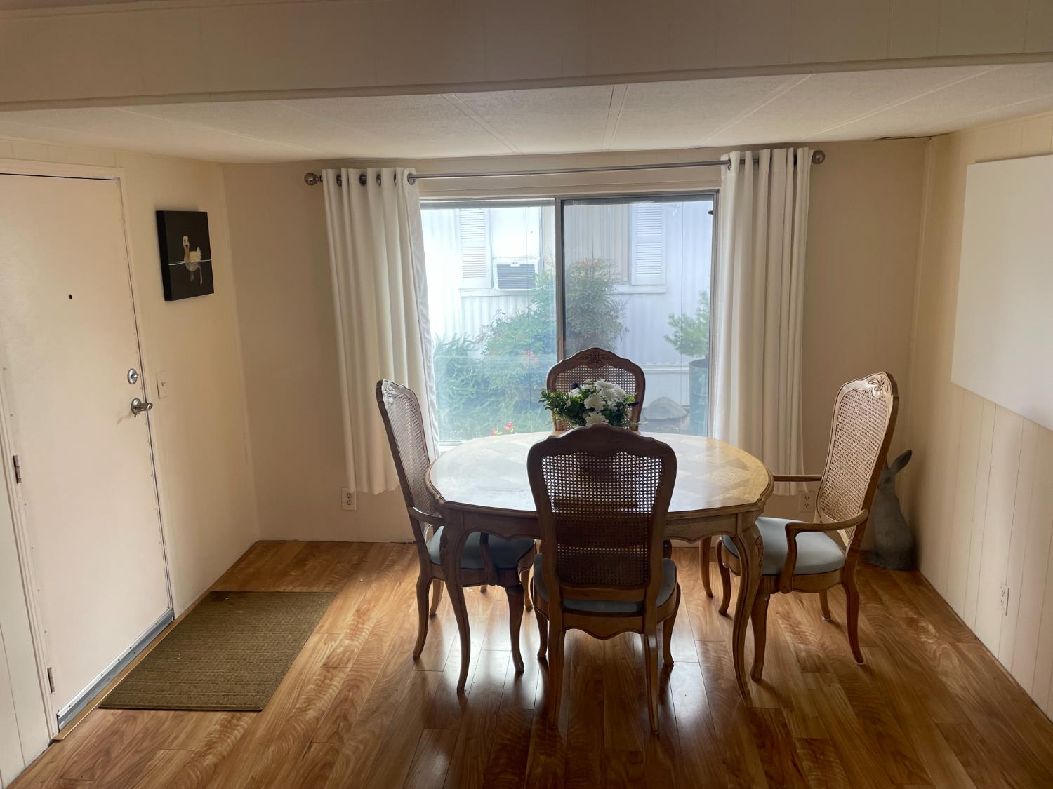 5835 Cherokee Road, Unit 42 Stockton, CA 95215 - Photo 10 of 24 a view of a dining room with furniture window and wooden floor