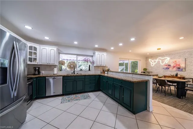 a kitchen with stainless steel appliances granite countertop a refrigerator and a stove top oven