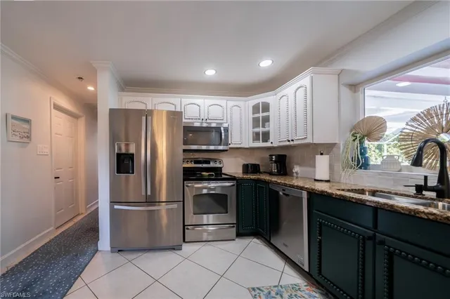a kitchen with stainless steel appliances granite countertop a refrigerator sink and cabinets