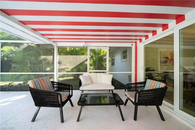 a balcony with furniture and a potted plant