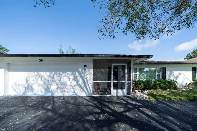 a view of a house with a window and a yard