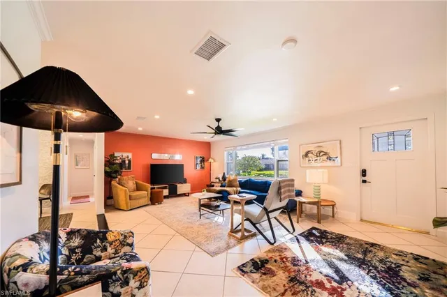 a living room with lots of furniture and a chandelier