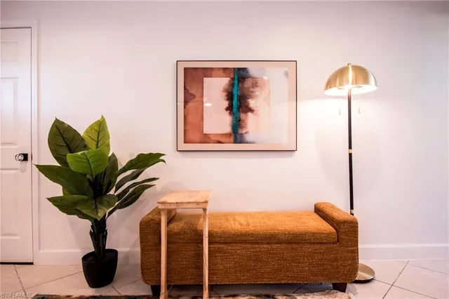 a bedroom with a bed and a potted plant