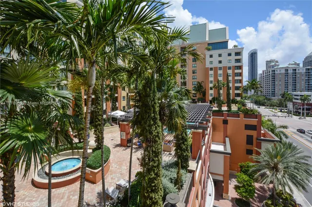 a view of swimming pool outdoor seating and city view