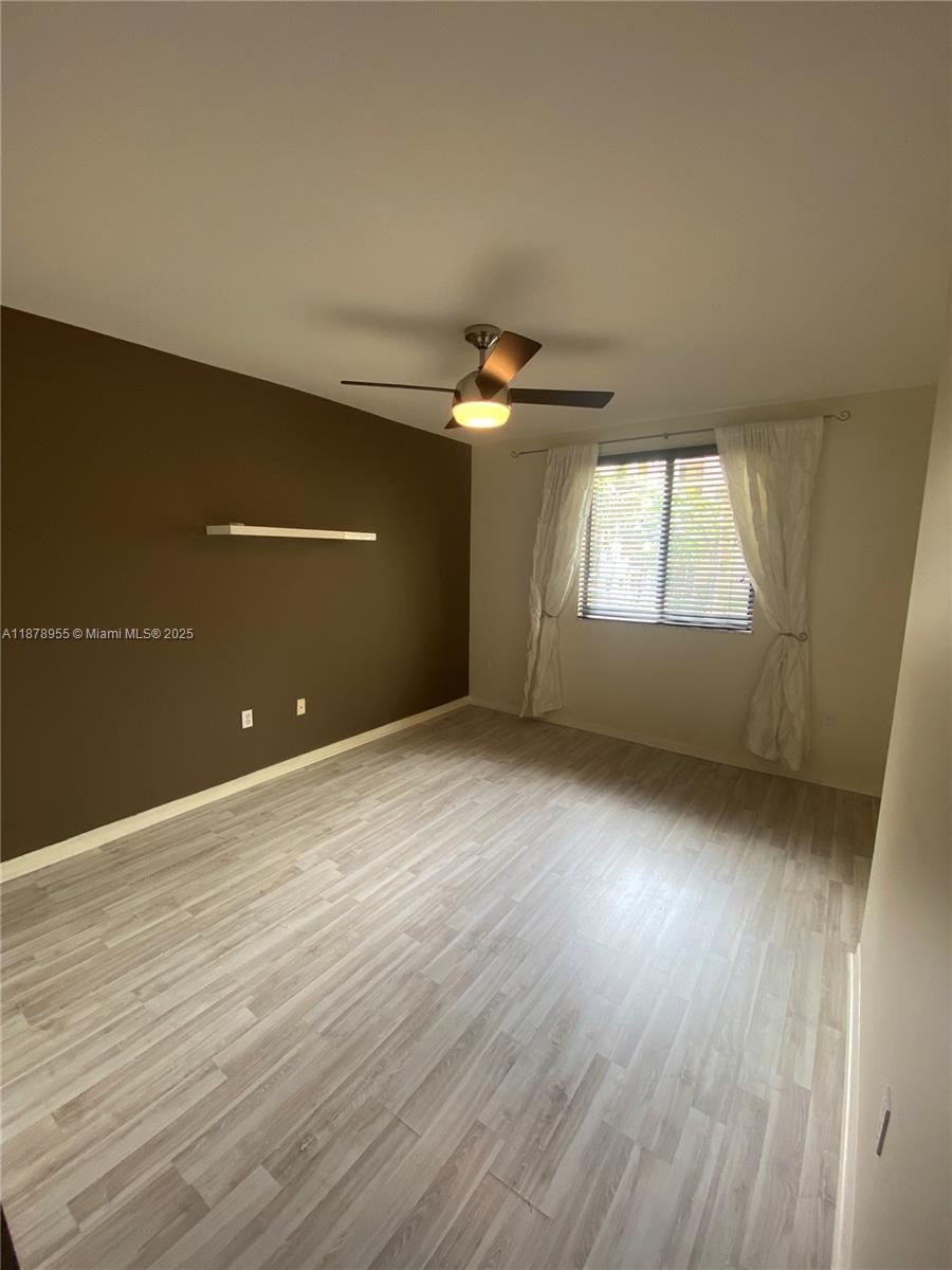 110 North Federal Highway, Unit 705 Fort Lauderdale, FL 33301 - Photo 6 of 16 an empty room with wooden floor and windows