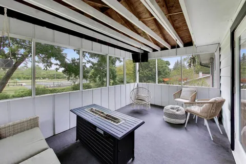 a living room with furniture and a floor to ceiling window