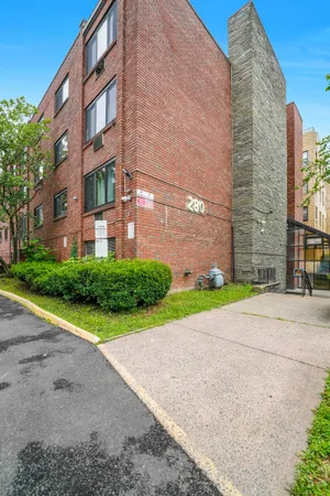 a view of a brick building next to a yard