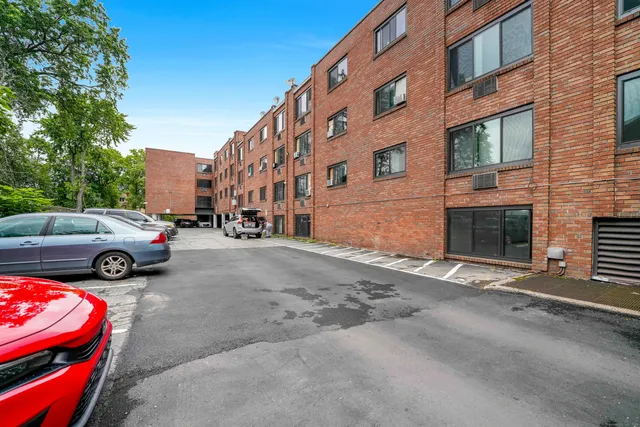 a view of a cars park in front of a building